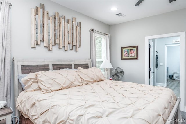 bedroom with hardwood / wood-style floors and ceiling fan