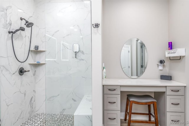 bathroom with vanity and tiled shower