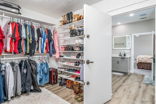 walk in closet featuring light hardwood / wood-style flooring