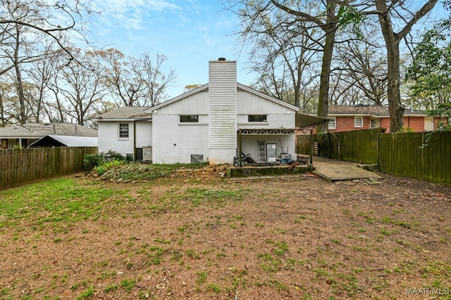 rear view of property featuring a patio area and a lawn