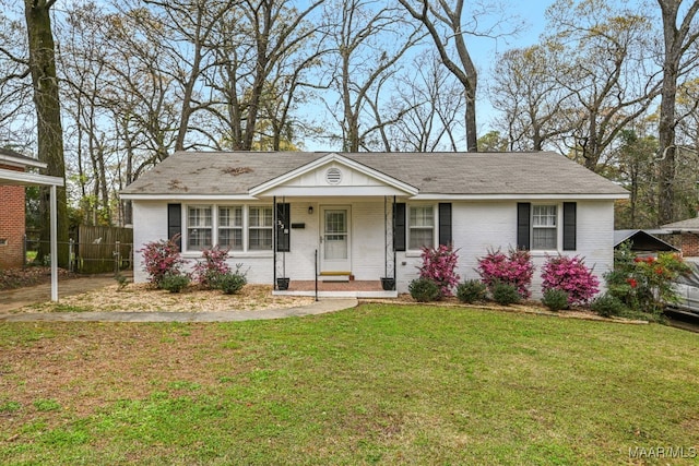 ranch-style home with a porch and a front yard