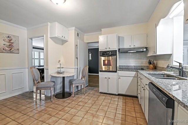 kitchen with white cabinetry, sink, light stone countertops, and appliances with stainless steel finishes