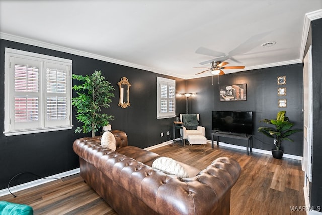 living room with crown molding, dark hardwood / wood-style floors, and ceiling fan