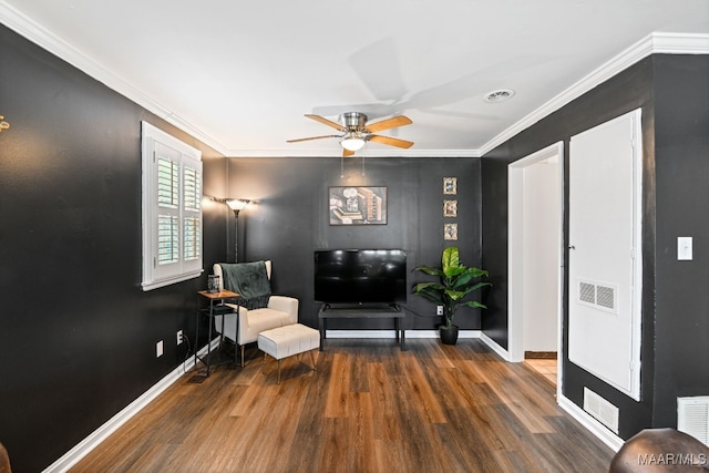 living area featuring ceiling fan, ornamental molding, and dark hardwood / wood-style flooring