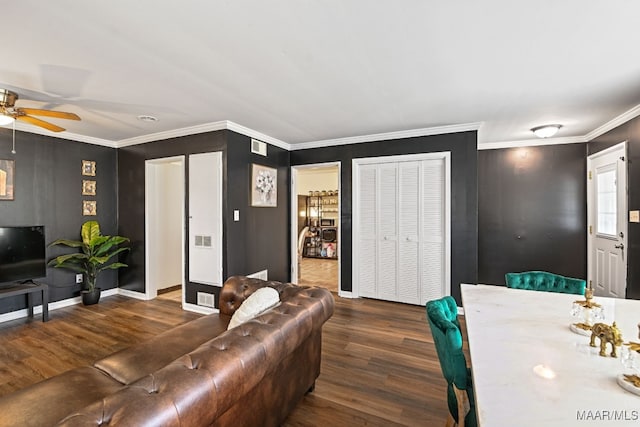 living room featuring crown molding, dark hardwood / wood-style floors, and ceiling fan