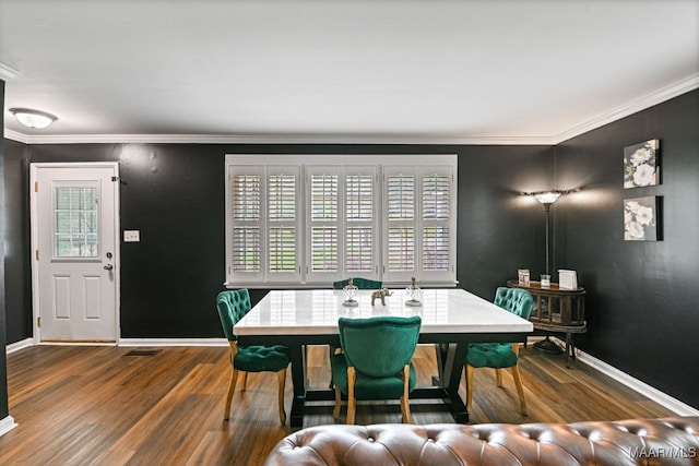 dining area featuring ornamental molding and hardwood / wood-style floors