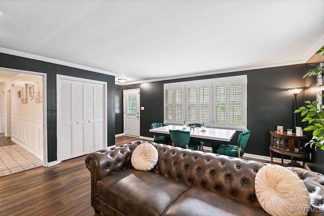 living room featuring ornamental molding and dark hardwood / wood-style flooring