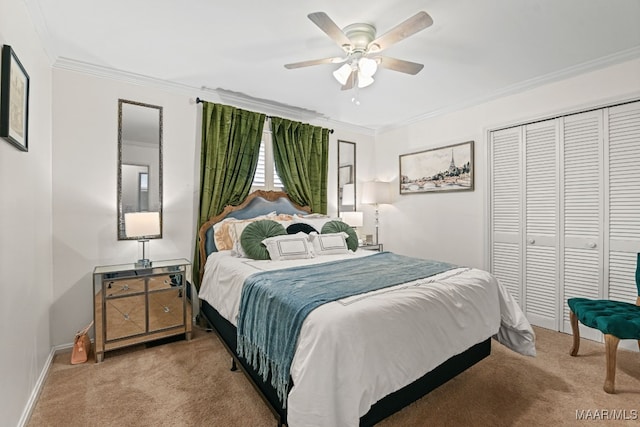 carpeted bedroom featuring ornamental molding, a closet, and ceiling fan