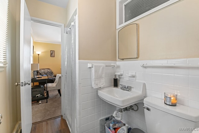 bathroom featuring hardwood / wood-style flooring, sink, tile walls, and toilet