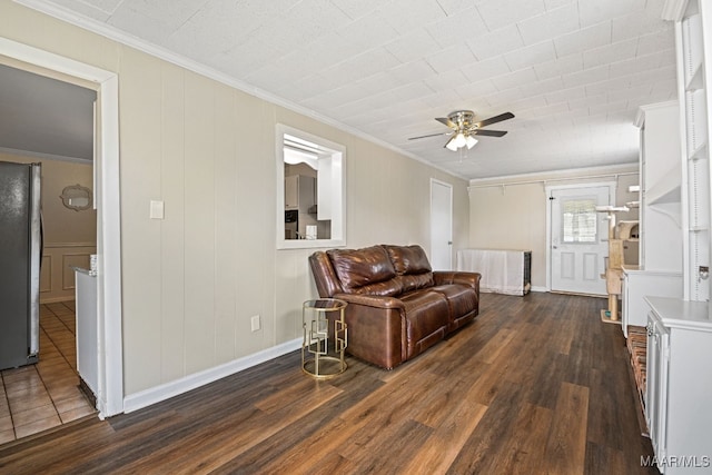 living room with crown molding, ceiling fan, and dark hardwood / wood-style floors