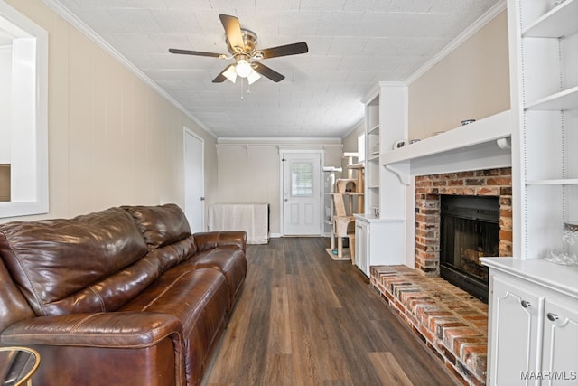 unfurnished living room with dark hardwood / wood-style floors, built in features, ceiling fan, crown molding, and a brick fireplace