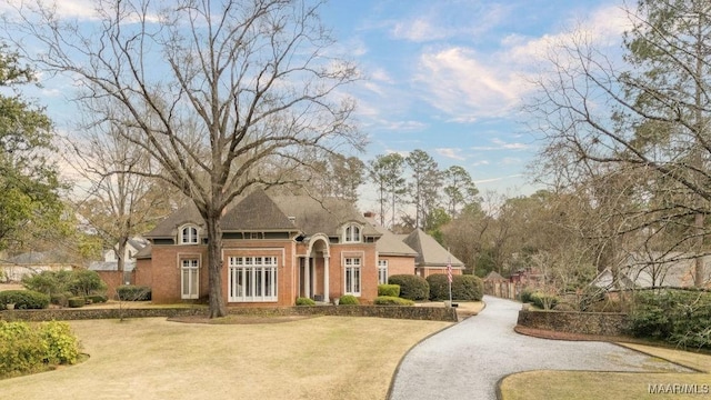 view of front of property with driveway and a front lawn