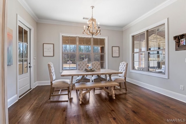 dining room featuring ornamental molding, dark wood-type flooring, and an inviting chandelier