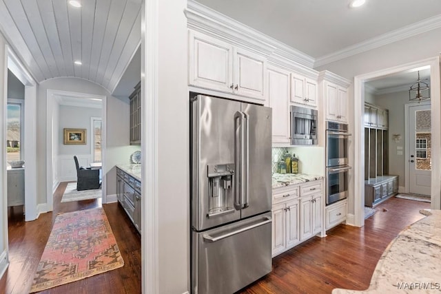 kitchen featuring white cabinetry, appliances with stainless steel finishes, dark hardwood / wood-style floors, and light stone counters