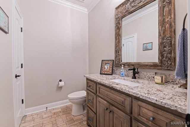 bathroom featuring crown molding, vanity, and toilet