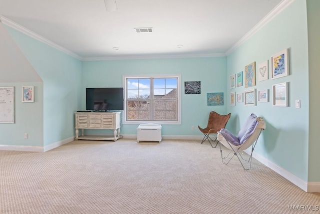 sitting room with ornamental molding and carpet flooring