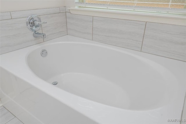 bathroom with a tub to relax in