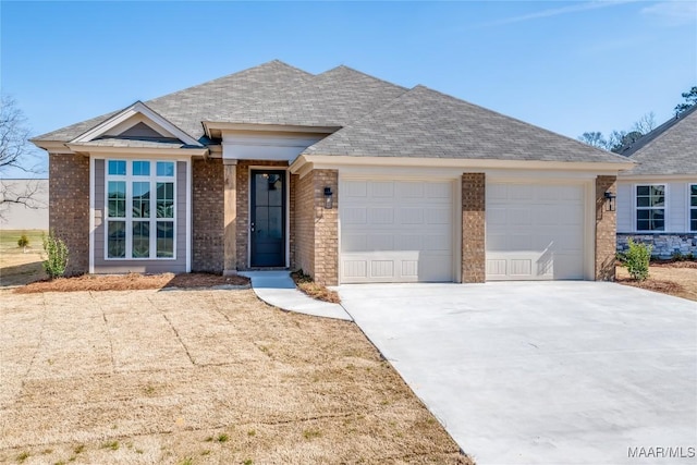 view of front of house with a garage, concrete driveway, brick siding, and a shingled roof