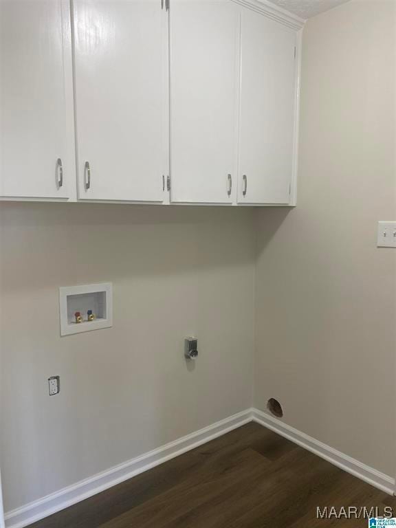 laundry room featuring hookup for a washing machine, dark wood-type flooring, and cabinets