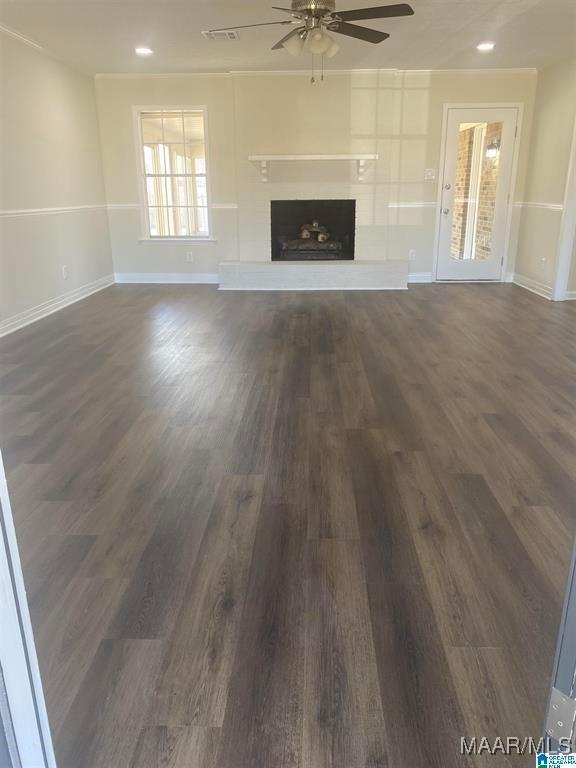 unfurnished living room featuring dark hardwood / wood-style floors and ceiling fan