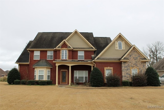 view of front of property with stone siding and brick siding