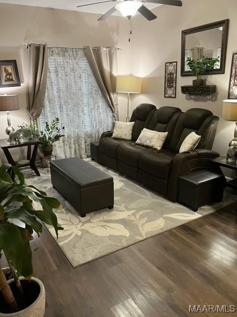 living room with wood finished floors and a ceiling fan