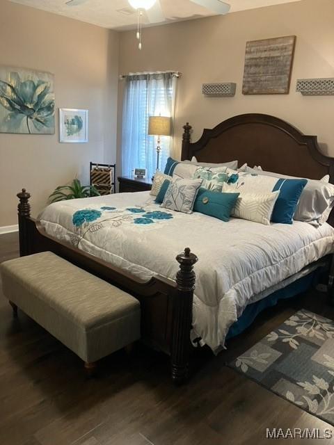 bedroom featuring a ceiling fan and dark wood-style flooring