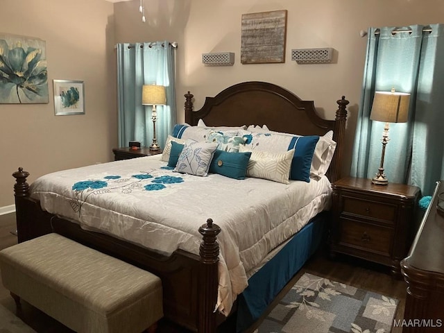 bedroom with dark wood-style floors