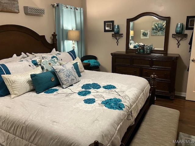 bedroom featuring dark wood finished floors and baseboards