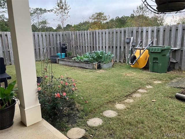 view of yard featuring a fenced backyard and a vegetable garden