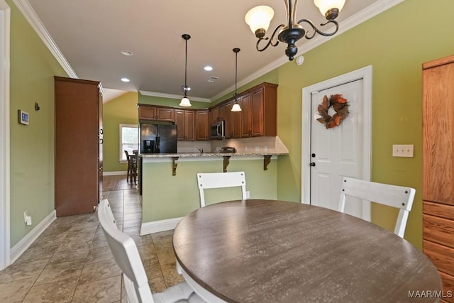 dining area featuring light tile patterned floors, ornamental molding, and a chandelier