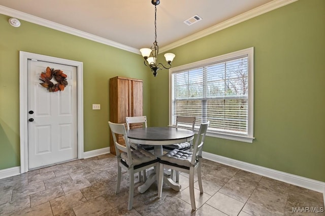 dining room with crown molding and a chandelier