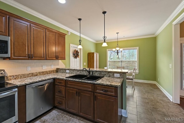 kitchen featuring sink, hanging light fixtures, kitchen peninsula, stainless steel appliances, and light stone countertops