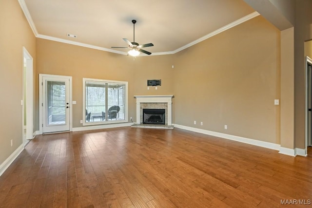 unfurnished living room with crown molding, wood-type flooring, and ceiling fan