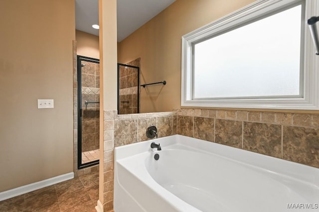 bathroom featuring tile patterned floors and shower with separate bathtub