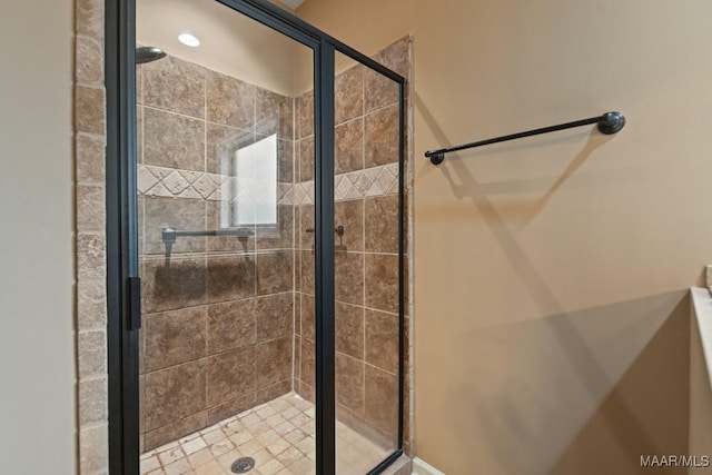 bathroom featuring a shower with door