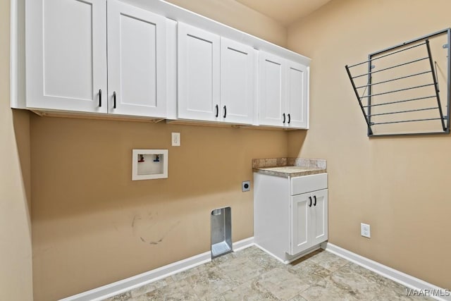 clothes washing area with washer hookup, cabinets, and hookup for an electric dryer