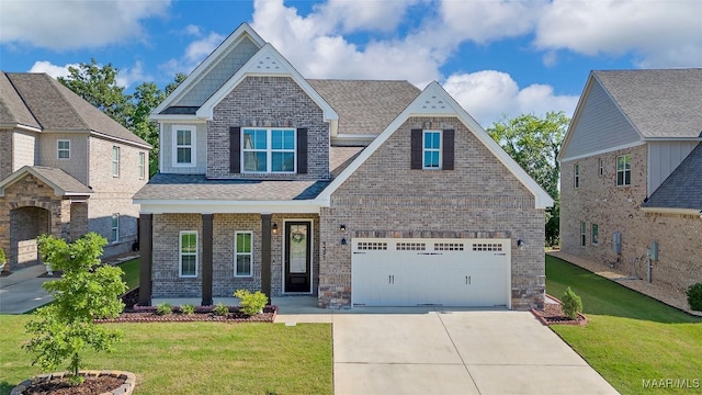 craftsman inspired home featuring a garage and a front yard