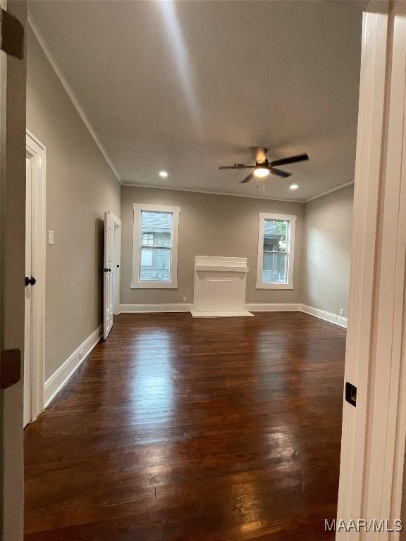 interior space featuring ornamental molding, dark hardwood / wood-style floors, and ceiling fan