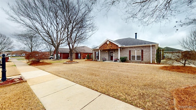 view of front facade featuring a front lawn and brick siding