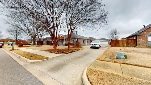 single story home featuring a residential view and fence