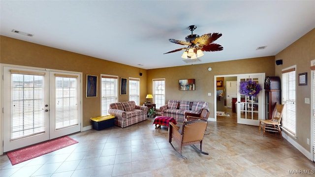 living area with ceiling fan, french doors, visible vents, and baseboards