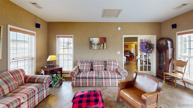 living room featuring visible vents, plenty of natural light, and tile patterned floors