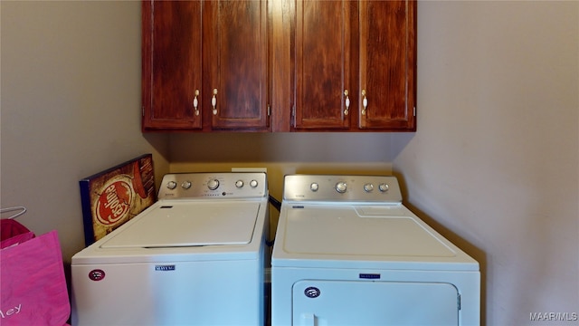 laundry room featuring cabinet space and separate washer and dryer