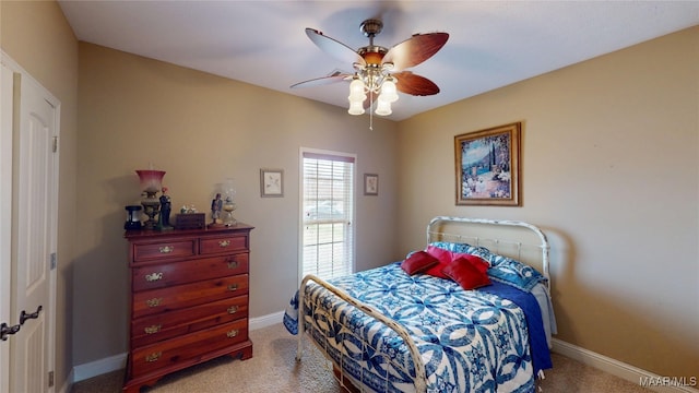 bedroom featuring light carpet, ceiling fan, and baseboards