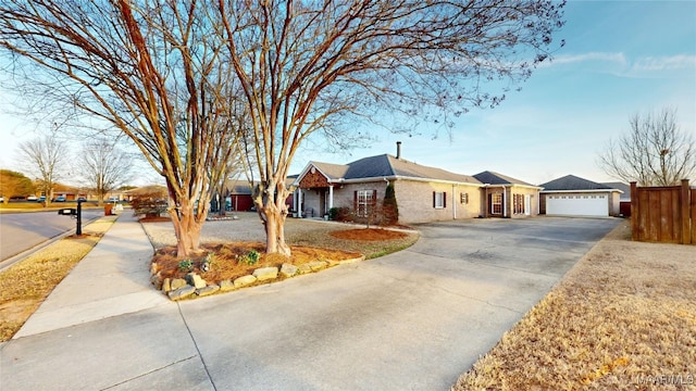 ranch-style house with brick siding, driveway, and fence