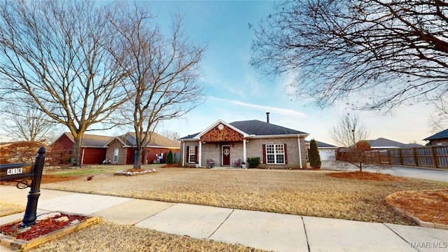 ranch-style house with brick siding, fence, and a front lawn