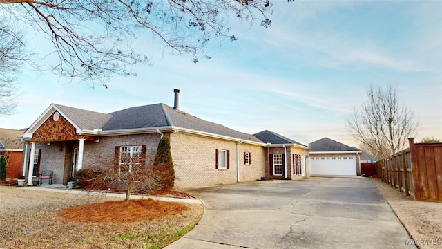 ranch-style home featuring an attached garage, brick siding, fence, concrete driveway, and roof with shingles