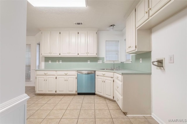 kitchen featuring white cabinets, light countertops, dishwasher, and a sink