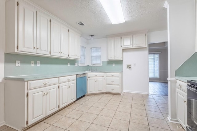 kitchen with dishwasher, light countertops, a sink, and white cabinetry